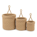 Set of three handwoven jute hanging wall baskets on a white background