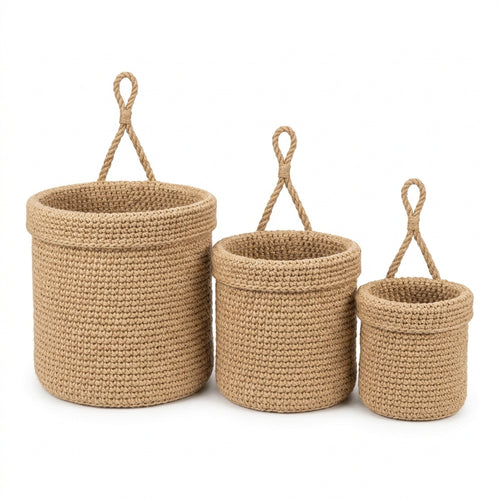 Set of three handwoven jute hanging wall baskets on a white background