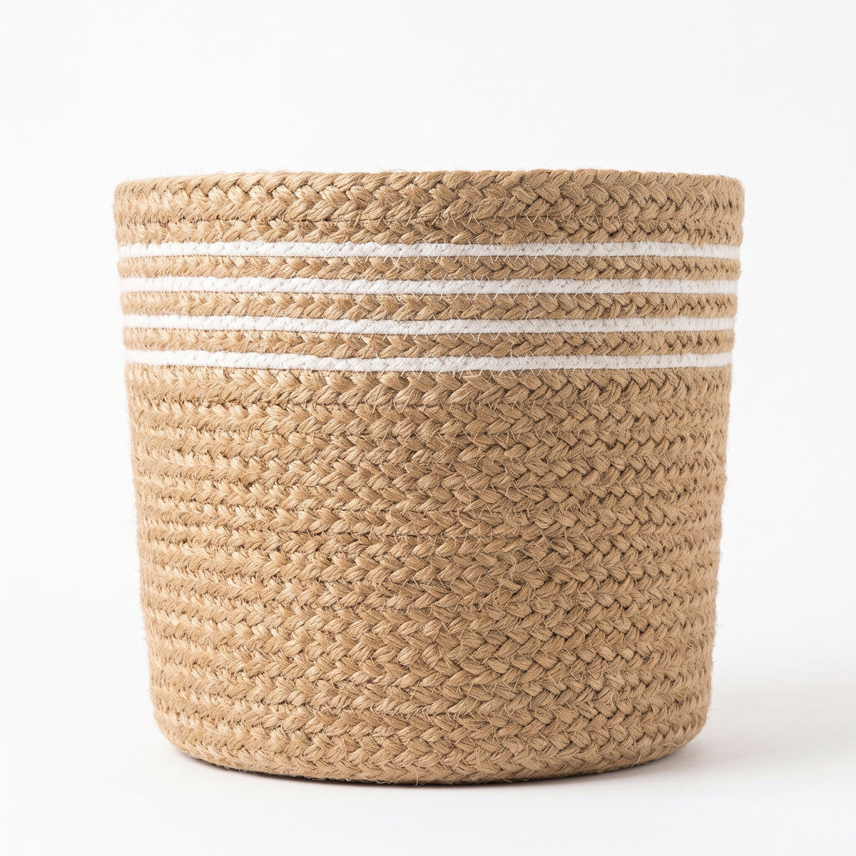 White striped jute planter basket beside a bed for size reference