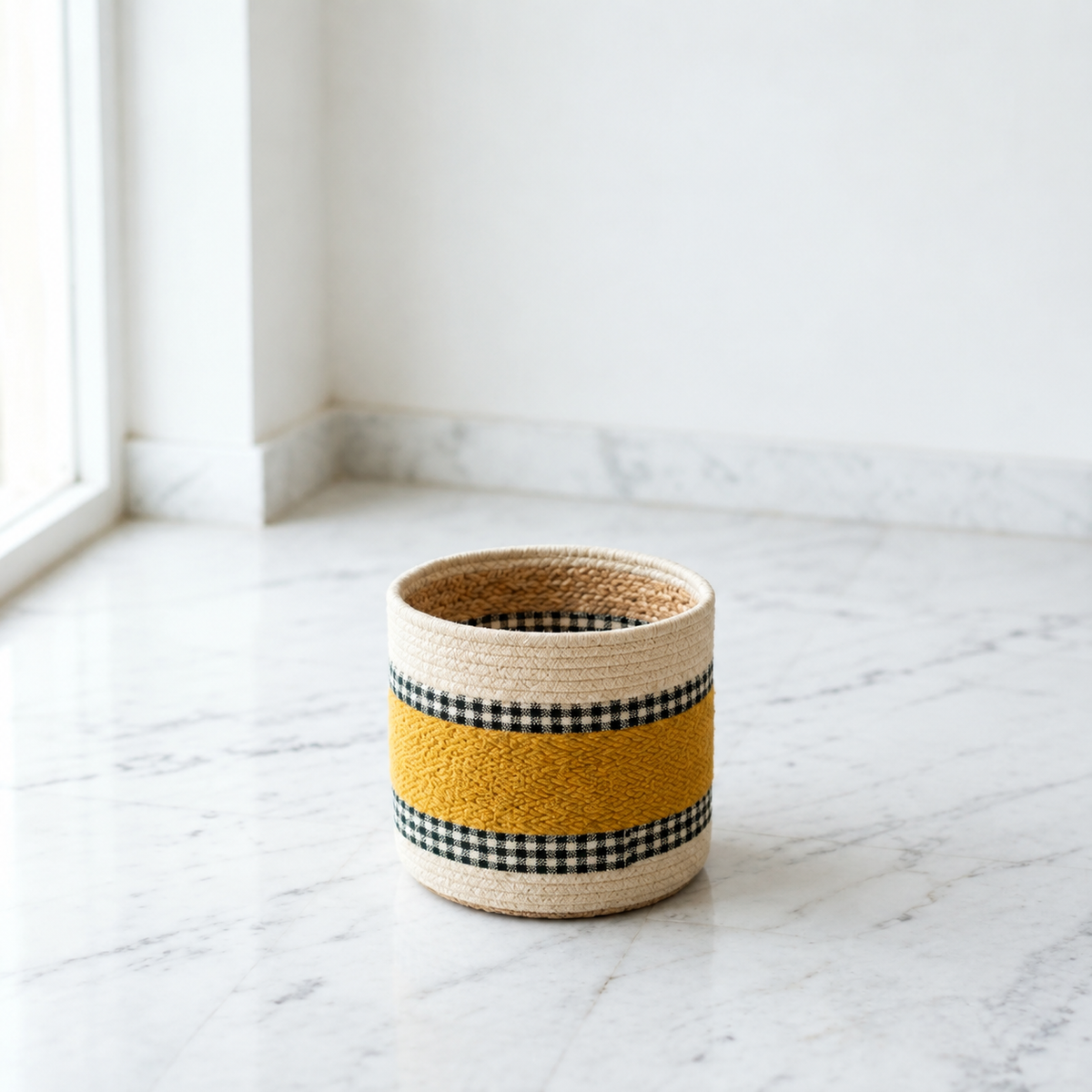 Mustard jute kilim planter basket holding a leafy plant in a styled living room